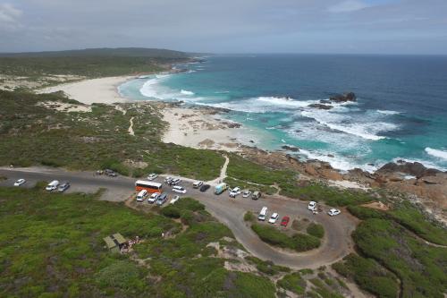 view from a drone over redgate beach carpark and the beach and ocean in the background